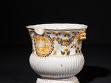 an image of a white and gold vase on a black background