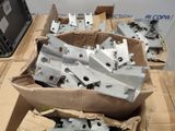 many pieces of metal in a box on a table