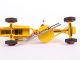 a yellow toy car that is sitting on a white surface