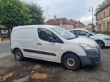 a small white van parked on the side of the road
