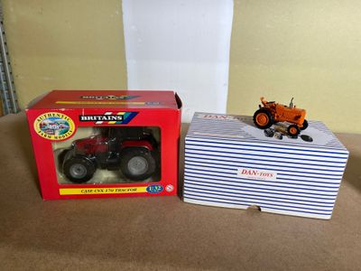 a box with a toy tractor and a box with a toy tractor