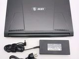 a laptop that is sitting on a table with a charger