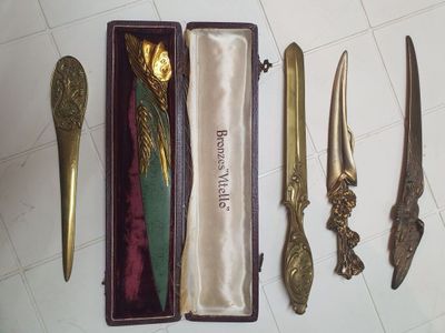 four different types of knives in a box on the floor