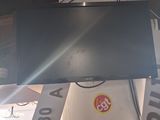 a television that is hanging from the ceiling in the room