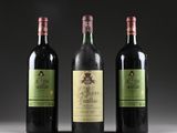three bottles of wine are lined up on a table