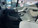 the interior of a car with the door open and the driver ' s seat down