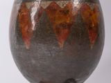 a vase that is sitting on top of a wooden stand