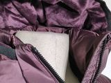 the jacket is purple and black with a hood on it