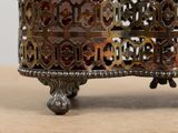 a close up of a decorative metal object on a table