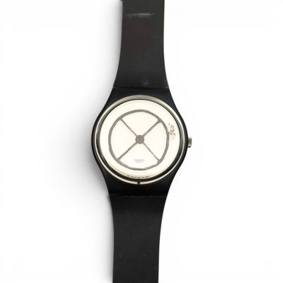 La montre est noire et blanche, avec un cadran blanc.