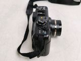 a black camera with a black strap attached to it