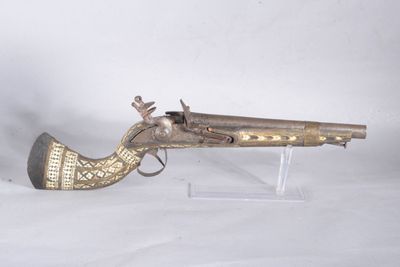 brass plated flintet pistol on clear acrylic stand on white background