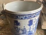 a large blue and white vase sitting on a table