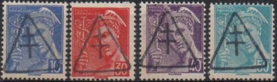 four different colored stamps of different shapes and sizes on a black background