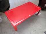 a red table that is sitting on the floor