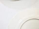 a white toilet with a white seat and a white bowl