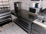a kitchen with a stove, oven, microwave, and other appliances
