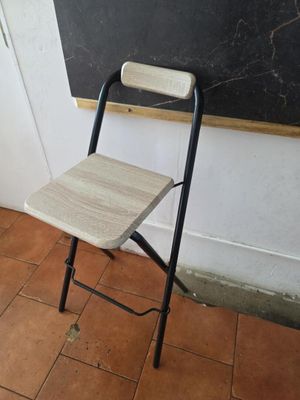 une chaise placée devant un tableau noir