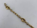 a close up of a gold chain on a white surface