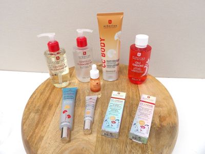 many different types of skin care products on a wooden tray