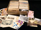 many old photos in a wooden box on a black table