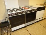 a stove and oven in a kitchen with tile flooring