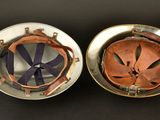 pair of antique brass and copper plated helmet covers