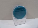 a small blue object in a clear box on a table