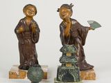 pair of asian figurines of a man and a woman holding a fan
