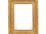 a gold frame on a white wall with a white background