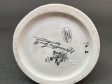 a white plate with a drawing on it sitting on a table