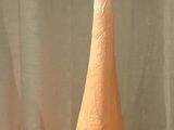 a vase that is sitting on a table in front of a curtain