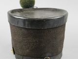a small box with a green ball on top of it