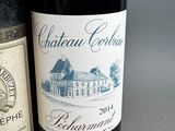 two bottles of wine sitting next to each other on a table