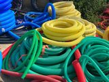 many different colored hoses on the ground next to each other