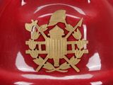a red fire hydrant with a gold emblem on it