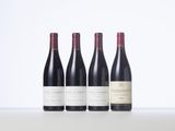 three bottles of wine are lined up on a table