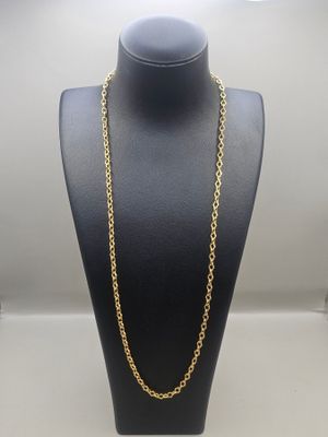 a gold chain necklace on a mannequin display