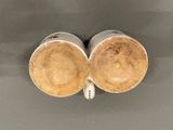 two coffee cups sitting next to each other on top of a table