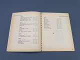 an open book with a list of items on it sitting on a table