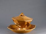 a gold tea cup and saucer on a saucer