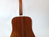 a close up of an acoustic guitar on a white background