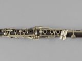a close up of a clarinet on a white surface