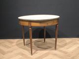 an image of a small table with a marble top on a wooden floor
