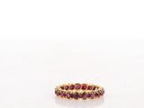 a close up of a gold ring with red stones