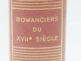 a close up of a red book with gold writing on it