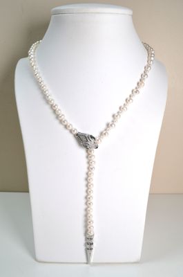 pearl and silver necklace on mannequin display with white background