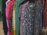 a rack of clothes in a clothing store with a lot of hangers