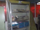 a refrigerator that is open in a room with many boxes on it