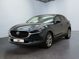 the mazda cx - 30 is parked in a showroom